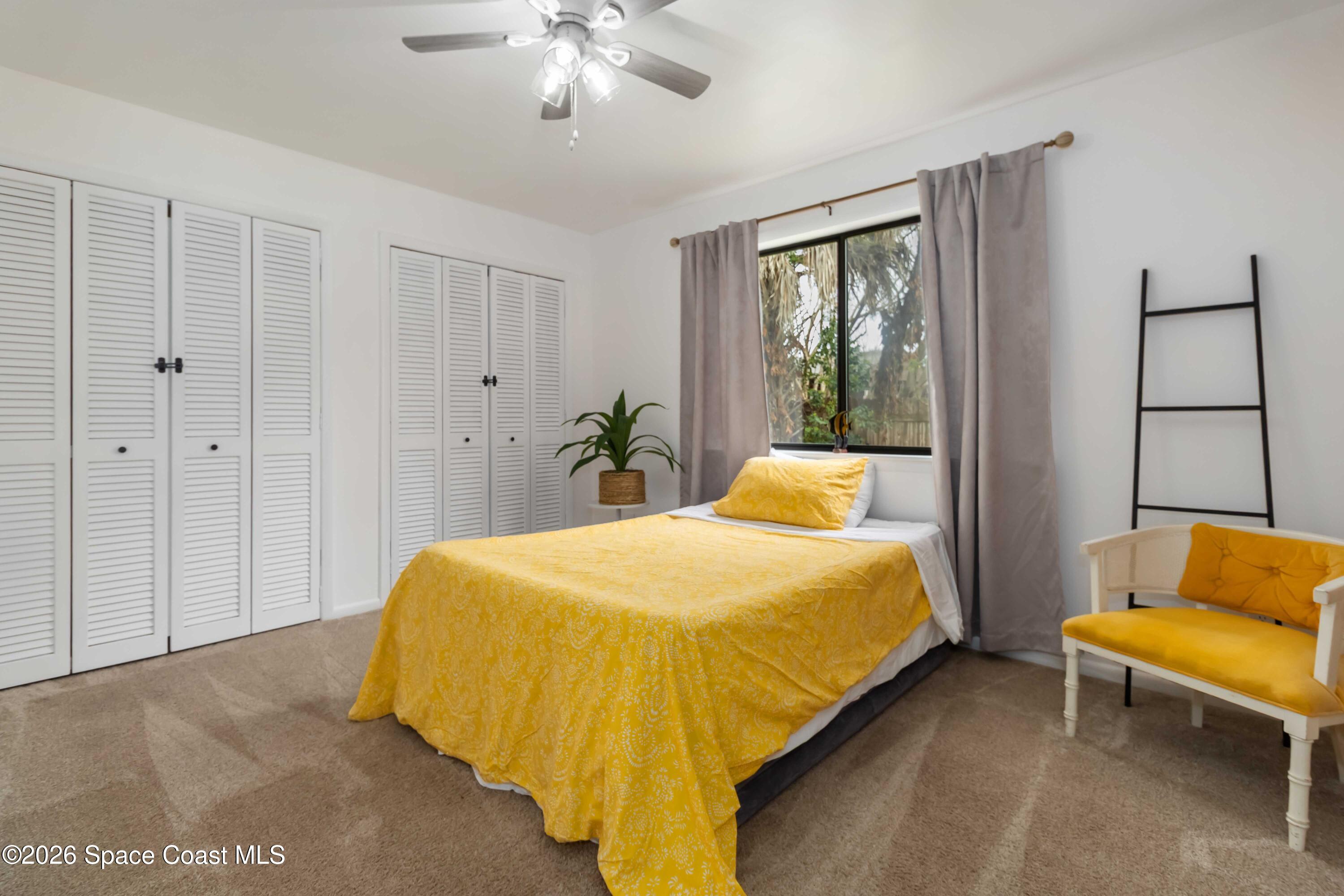 21 Branch Street Melbourne, FL 32901 - Photo 25 of 30 a bedroom with a bed and a couch