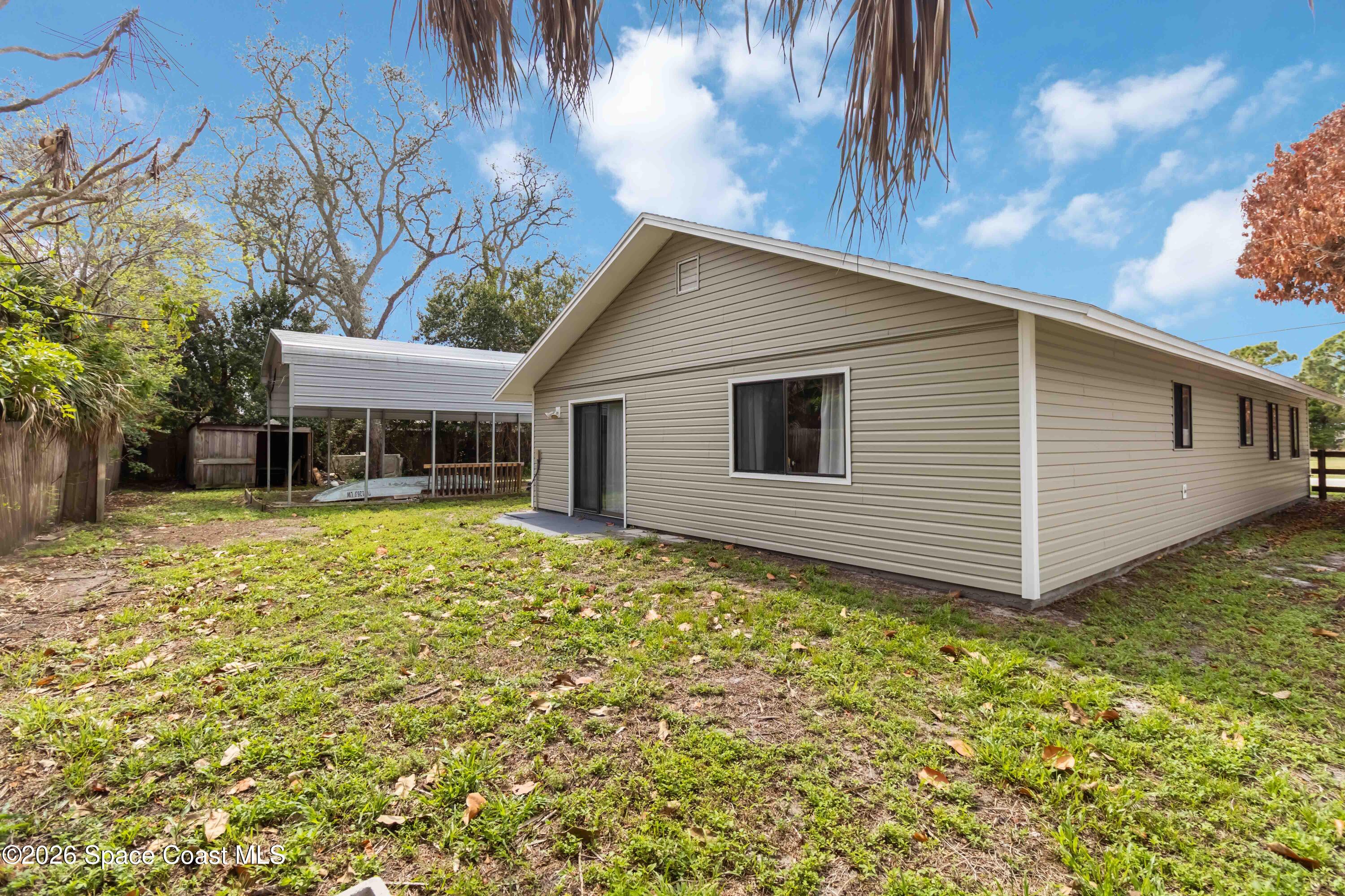 21 Branch Street Melbourne, FL 32901 - Photo 30 of 30 a backyard of a house with large trees and table and chairs