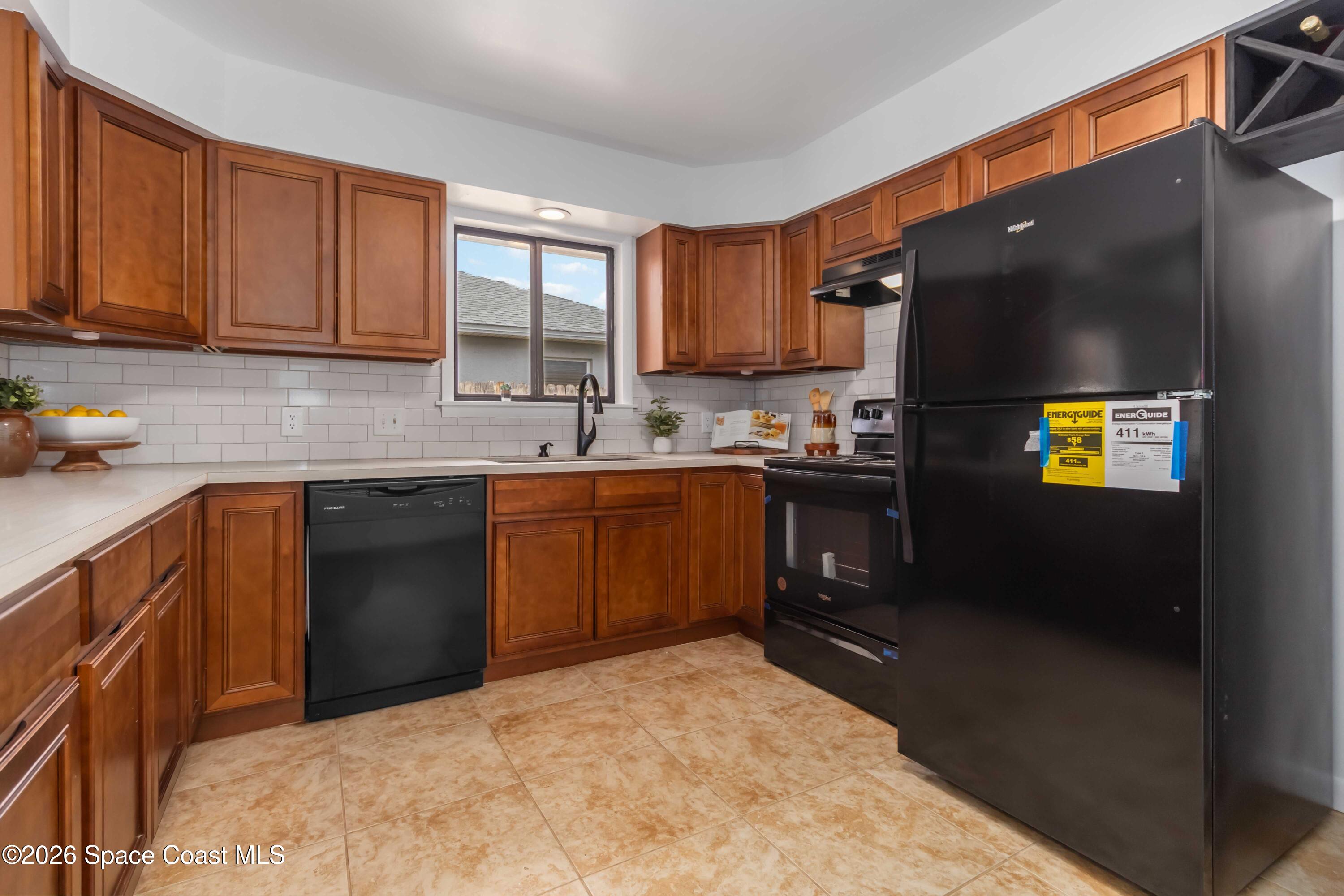 21 Branch Street Melbourne, FL 32901 - Photo 10 of 30 a kitchen with a sink a stove and cabinets