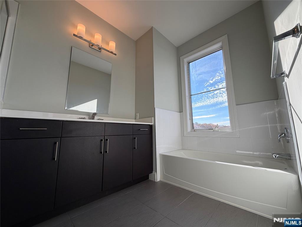 2001 Hudson Terrace, Unit 501 Fort Lee, NJ 07024 - Photo 11 of 23 a bathroom with a bathtub and a sink