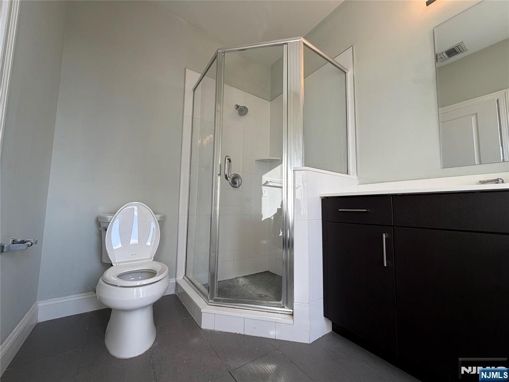 2001 Hudson Terrace, Unit 501 Fort Lee, NJ 07024 - Photo 12 of 23 a bathroom with a toilet a sink and shower