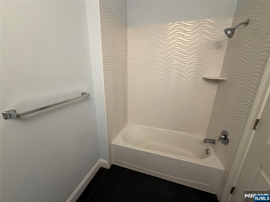 2001 Hudson Terrace, Unit 501 Fort Lee, NJ 07024 - Photo 17 of 23 a bathroom with a bathtub