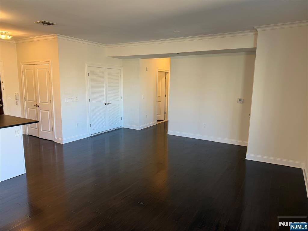 2001 Hudson Terrace, Unit 501 Fort Lee, NJ 07024 - Photo 5 of 23 a view of an empty room with wooden floor and a window
