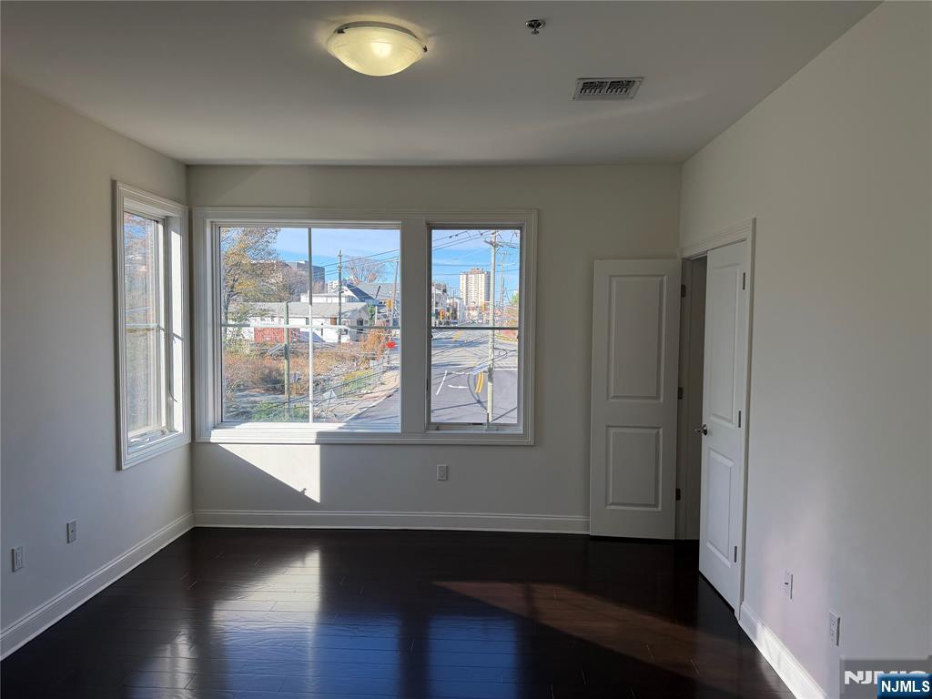 2001 Hudson Terrace, Unit 501 Fort Lee, NJ 07024 - Photo 8 of 23 a view of an empty room with wooden floor and a window
