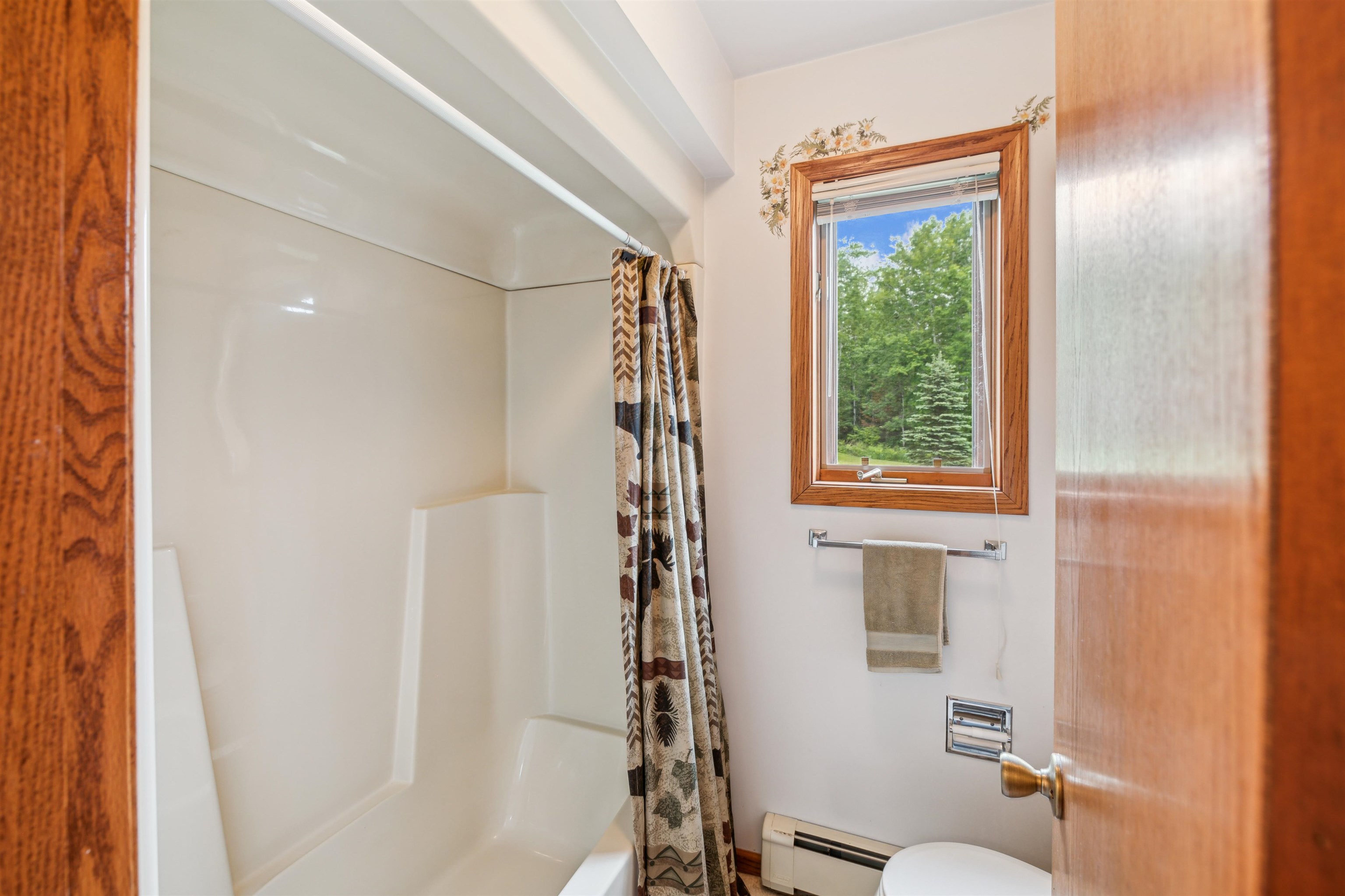 5948 Lavaque Road Duluth, MN 55803 - Photo 13 of 22 Bathroom featuring a baseboard heating unit and shower / bath combination with curtain