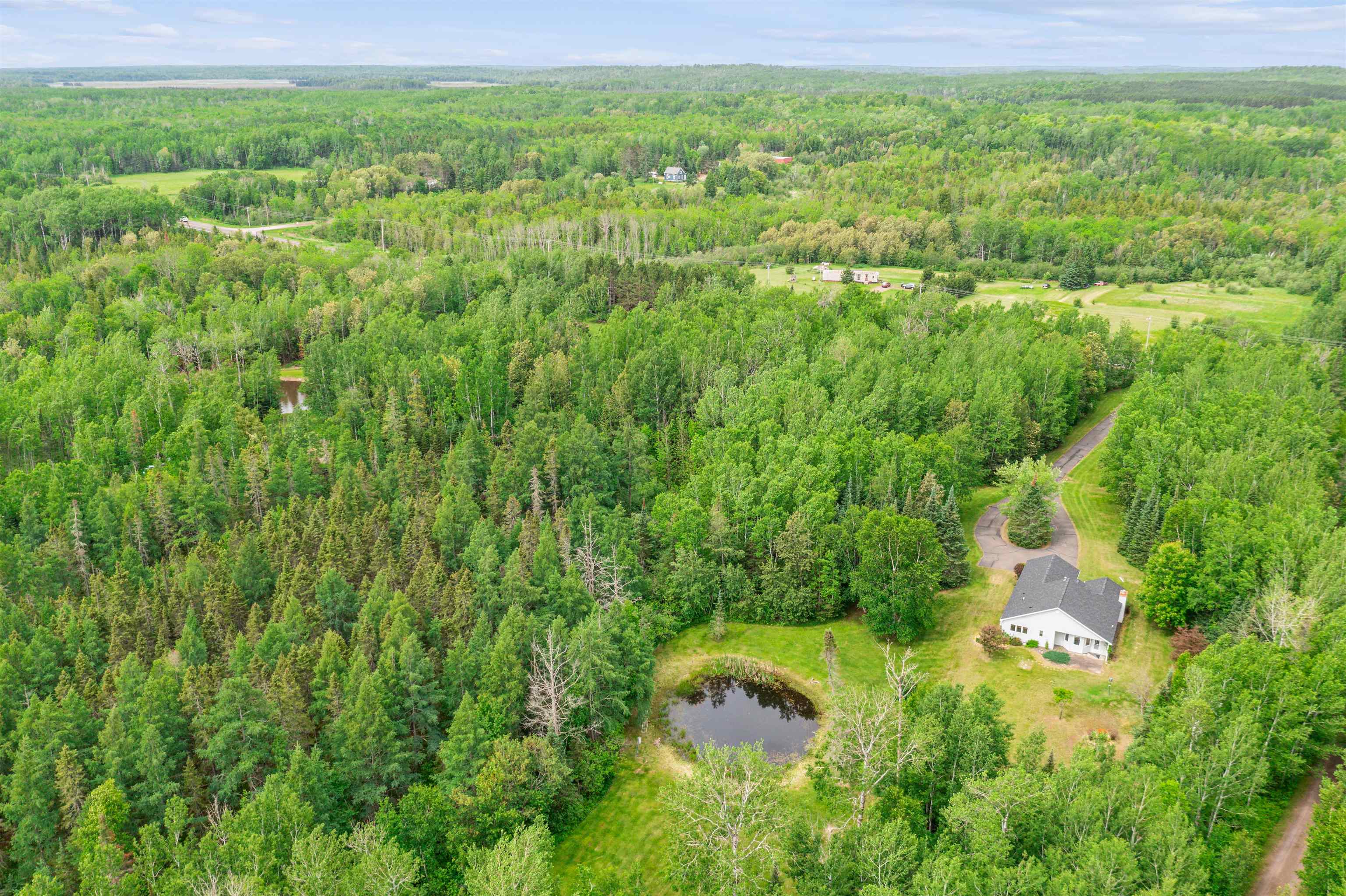 5948 Lavaque Road Duluth, MN 55803 - Photo 21 of 22 Bird's eye view of a heavily wooded area and a nearby body of water