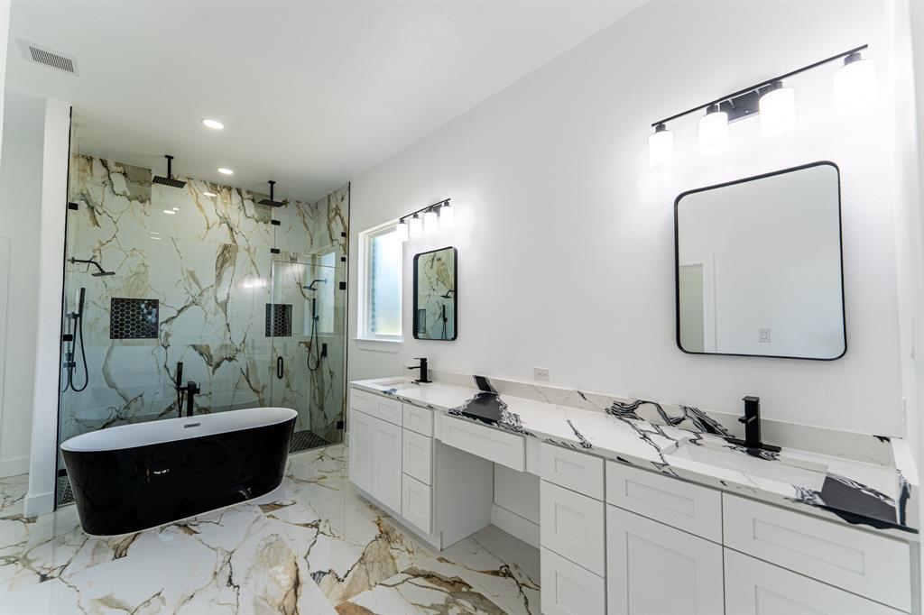 2147 Heath Street Sulphur Springs, TX 75482 - Photo 11 of 40 a bathroom with a double vanity sink mirror and bathtub