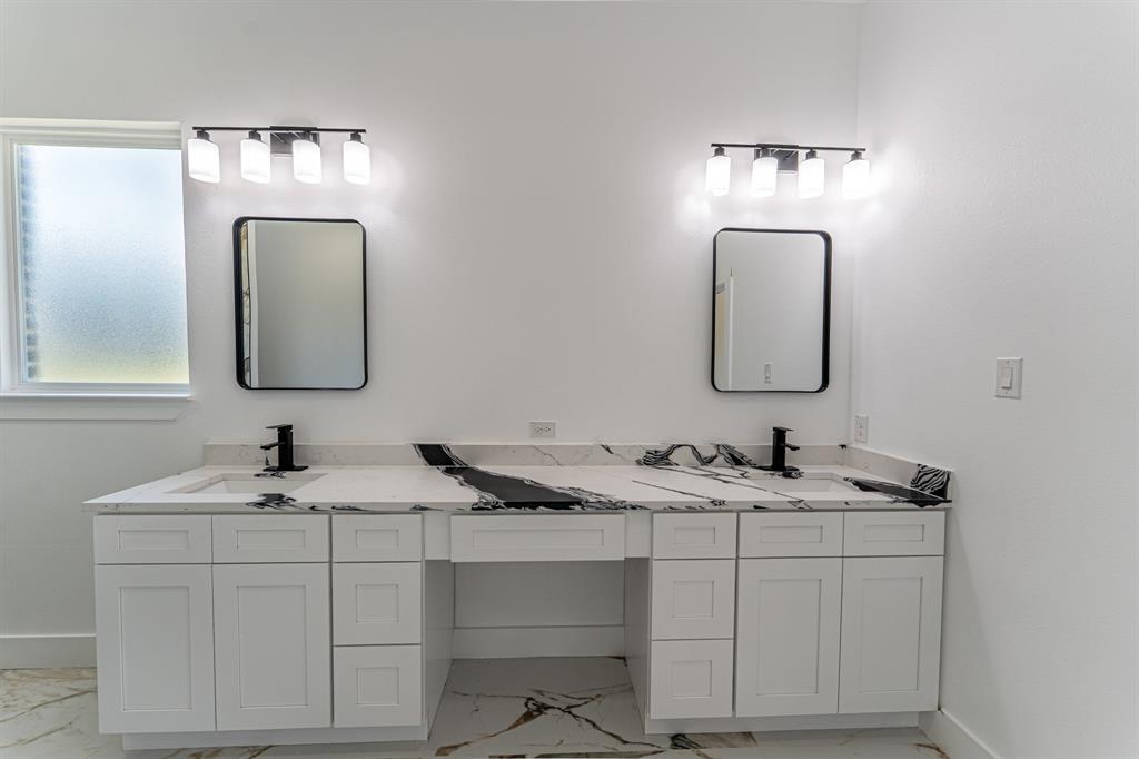 2147 Heath Street Sulphur Springs, TX 75482 - Photo 12 of 40 a bathroom with a sink and a mirror