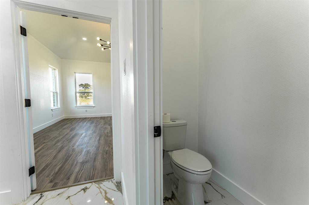 2147 Heath Street Sulphur Springs, TX 75482 - Photo 13 of 40 a bathroom with a toilet and a sink