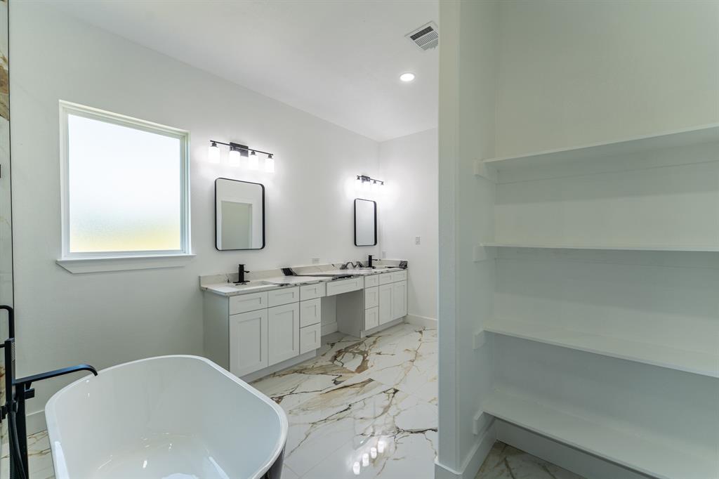2147 Heath Street Sulphur Springs, TX 75482 - Photo 16 of 40 a bathroom with a sink and a mirror