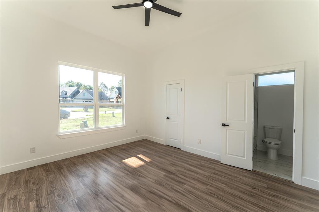 2147 Heath Street Sulphur Springs, TX 75482 - Photo 18 of 40 an empty room with wooden floor and windows