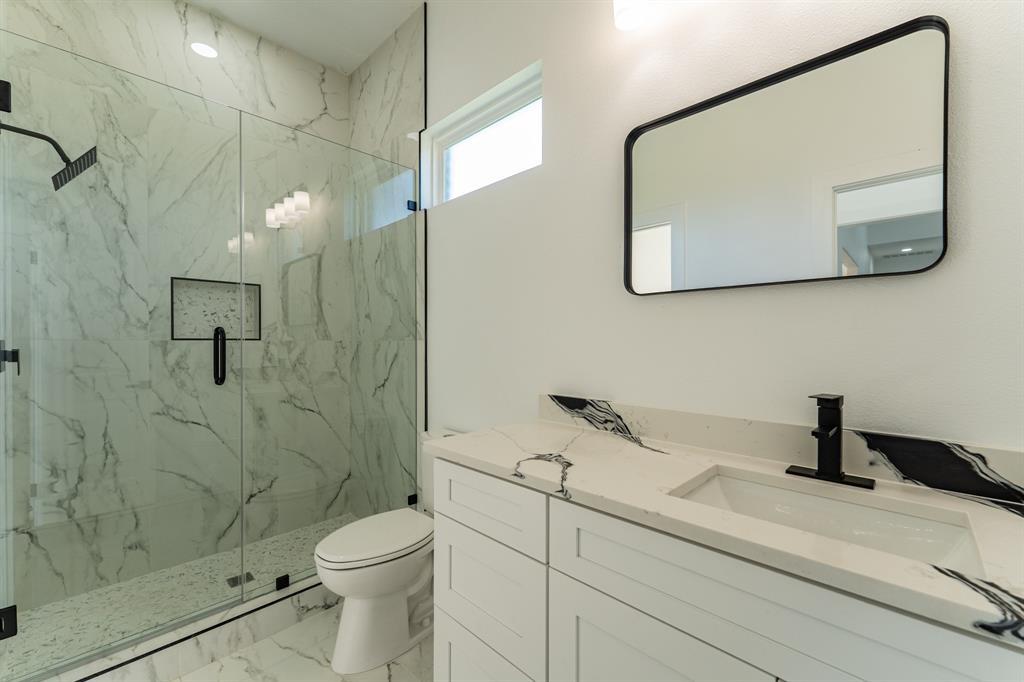 2147 Heath Street Sulphur Springs, TX 75482 - Photo 19 of 40 a bathroom with a toilet sink and mirror