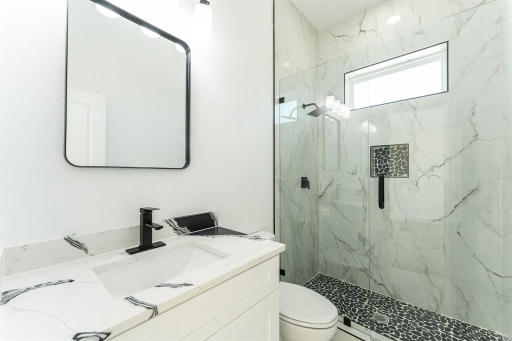2147 Heath Street Sulphur Springs, TX 75482 - Photo 22 of 40 a bathroom with a sink a toilet and shower