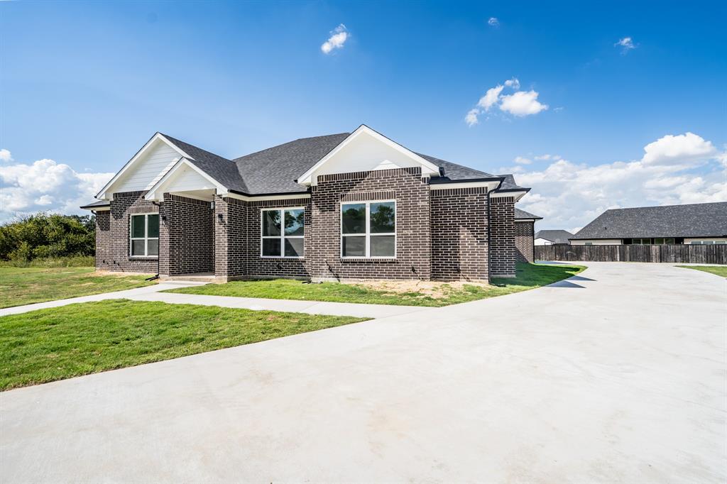 2147 Heath Street Sulphur Springs, TX 75482 - Photo 39 of 40 a front view of a house with a yard and garage