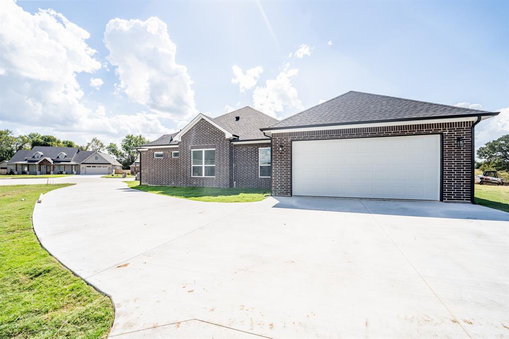 2147 Heath Street Sulphur Springs, TX 75482 - Photo 40 of 40 a view of a white house with a swimming pool and a yard