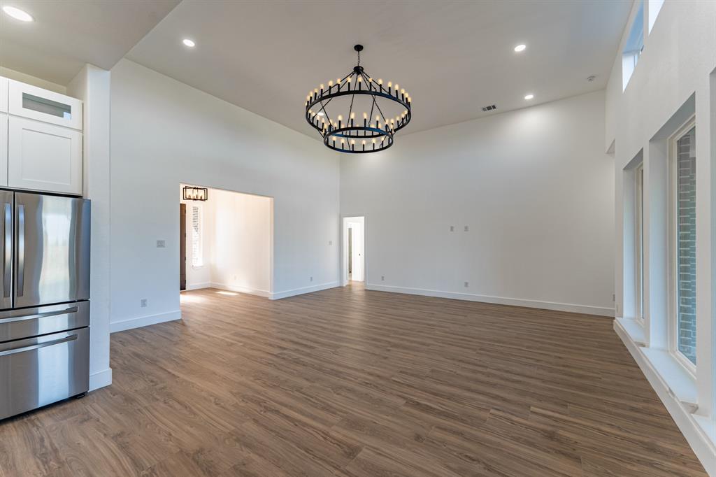 2147 Heath Street Sulphur Springs, TX 75482 - Photo 6 of 40 a view of an empty room with wooden floor and windows
