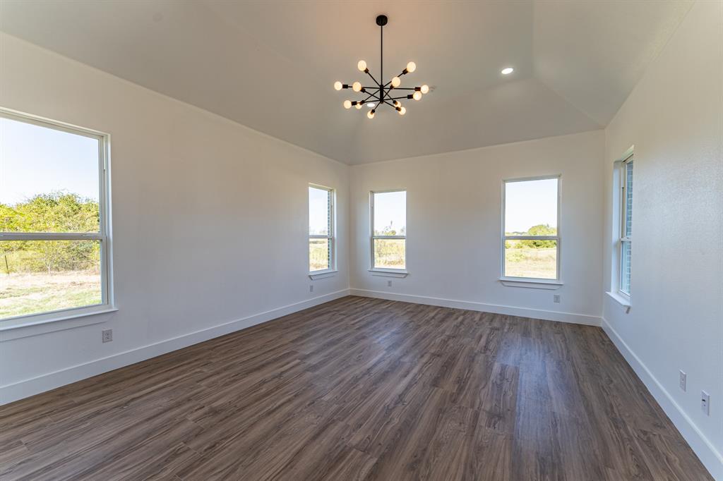 2147 Heath Street Sulphur Springs, TX 75482 - Photo 9 of 40 a view of an empty room with wooden floor and a window