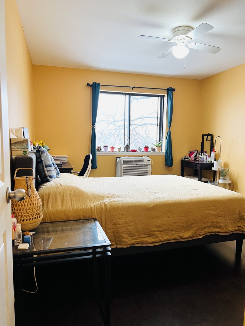 4624 North Commons Drive, Unit 307 Chicago, IL 60656 - Photo 17 of 18 a bed sitting in a bedroom next to a window