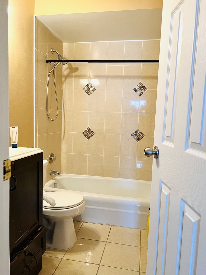4624 North Commons Drive, Unit 307 Chicago, IL 60656 - Photo 18 of 18 a bathroom with a sink toilet and shower