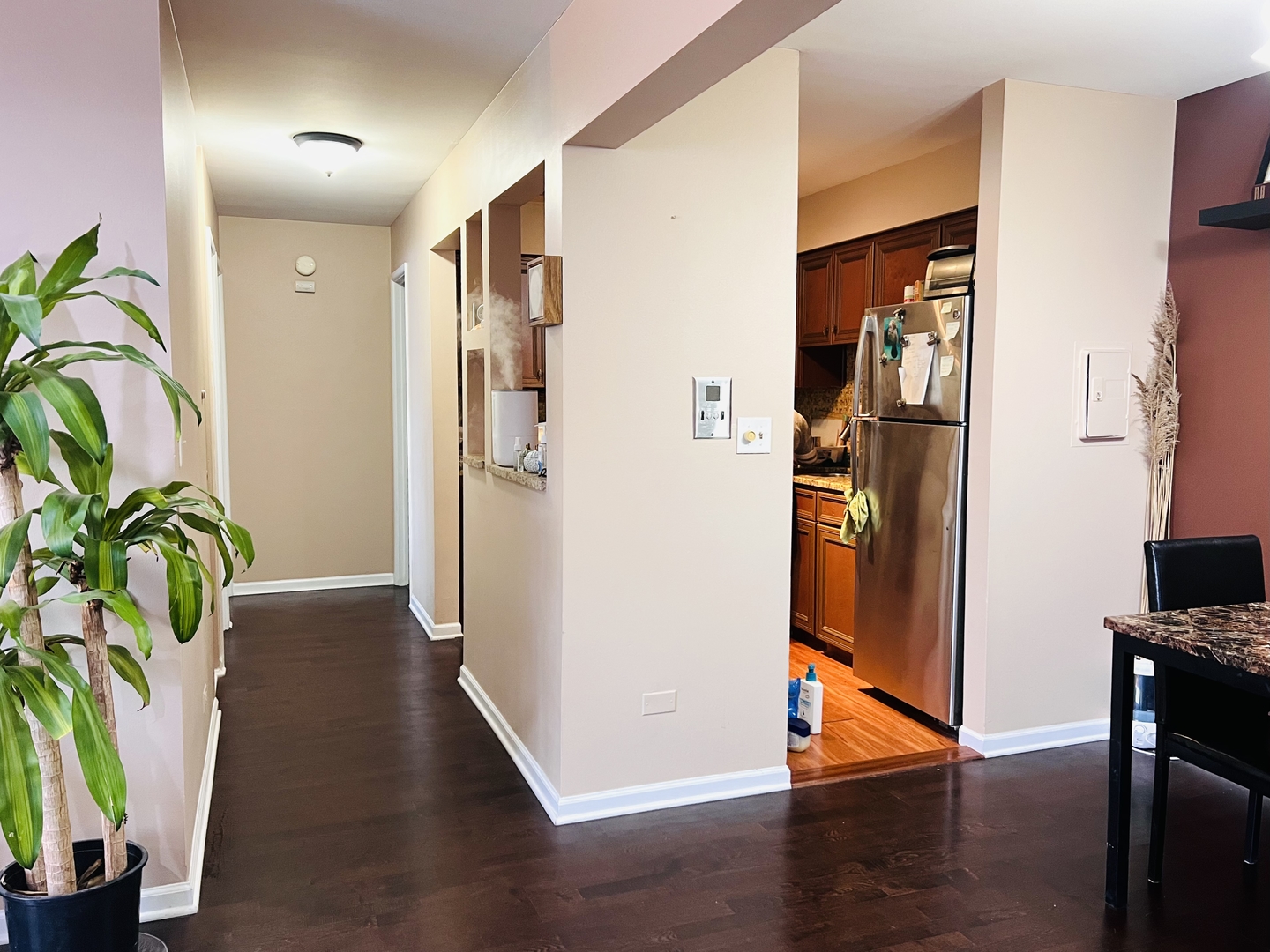 4624 North Commons Drive, Unit 307 Chicago, IL 60656 - Photo 8 of 18 a view of a hallway with wooden floor and a dining room