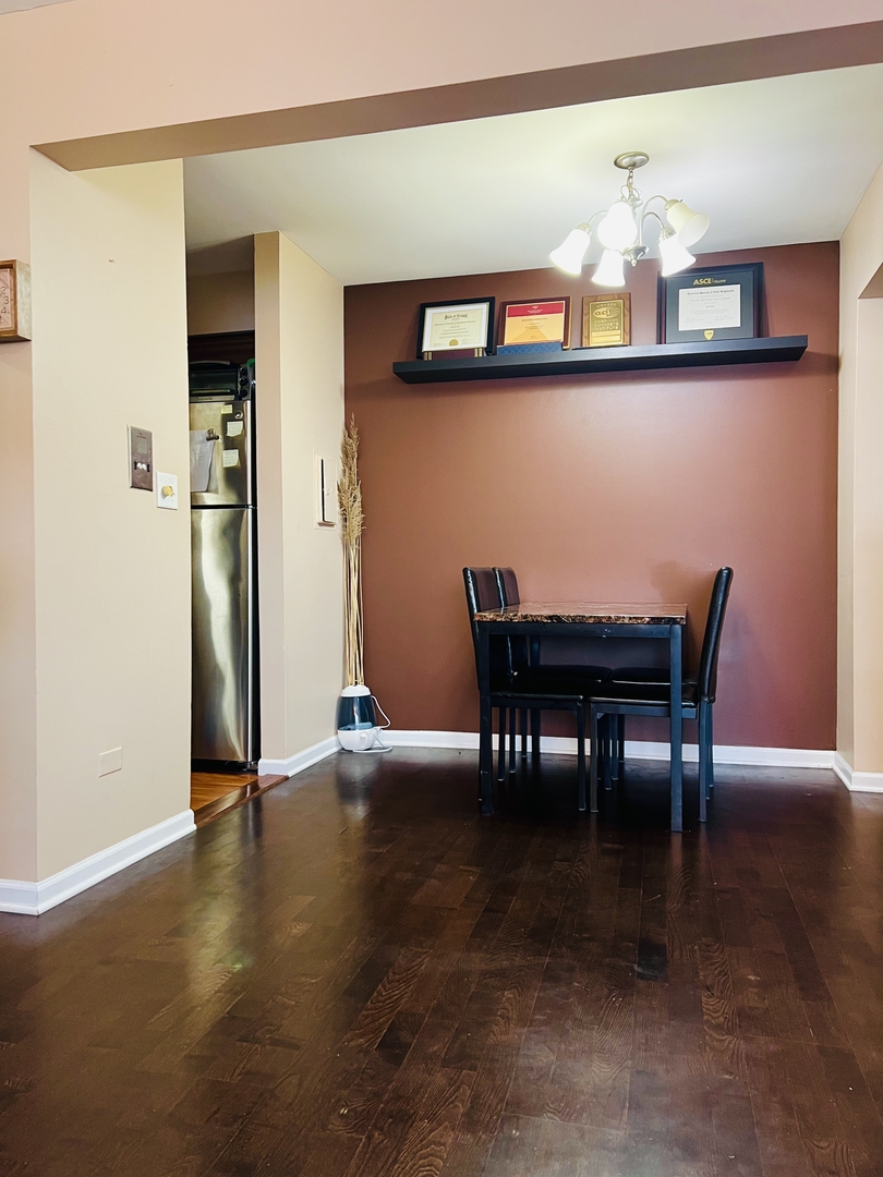 4624 North Commons Drive, Unit 307 Chicago, IL 60656 - Photo 9 of 18 a view of a dining room with furniture and chandelier
