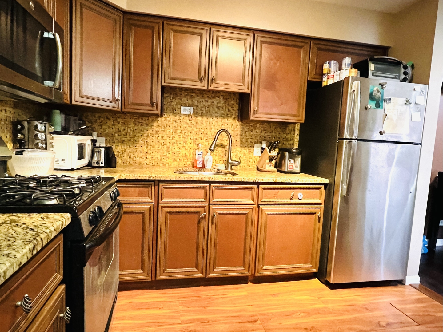 4624 North Commons Drive, Unit 307 Chicago, IL 60656 - Photo 10 of 18 a kitchen with stainless steel appliances granite countertop a refrigerator stove and sink