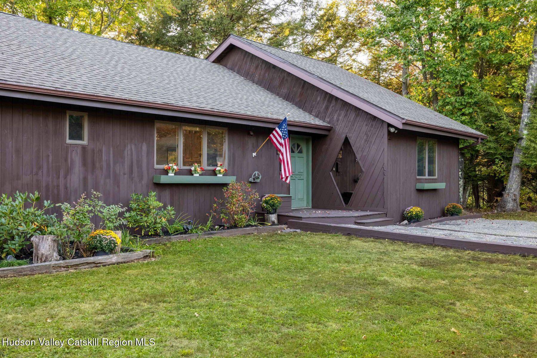 a view of a house with backyard and patio