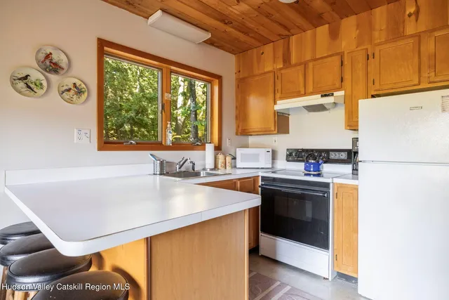 a kitchen with stainless steel appliances granite countertop a sink and a refrigerator