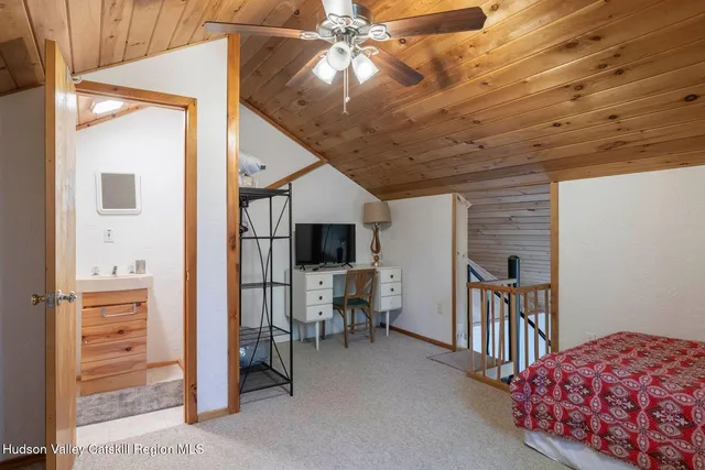 a bedroom with furniture and a window