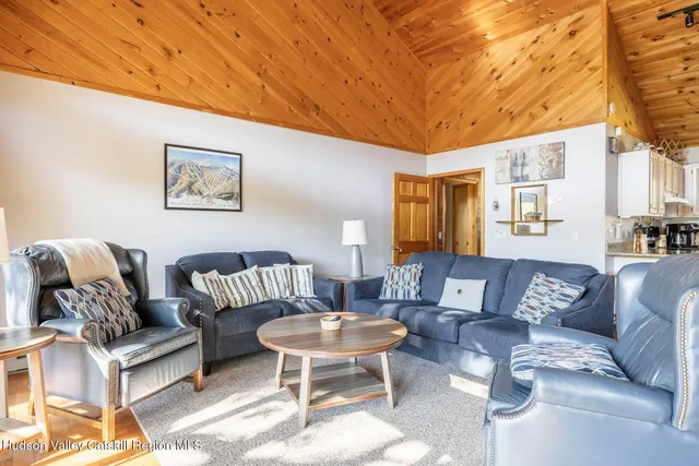 a living room with furniture a lamp a rug and a table