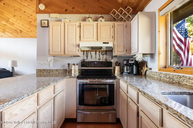 a kitchen with a stove and white cabinets
