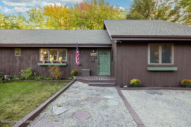 a front view of a house with garden