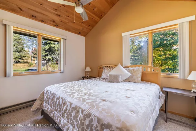 a bedroom with a large bed and a window