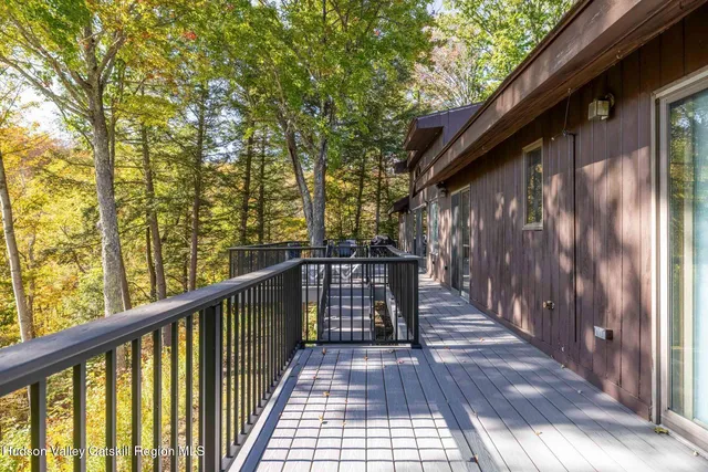a view of balcony with wooden floor and fence