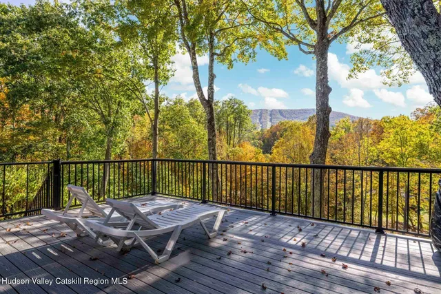 a view of balcony with wooden floor and fence