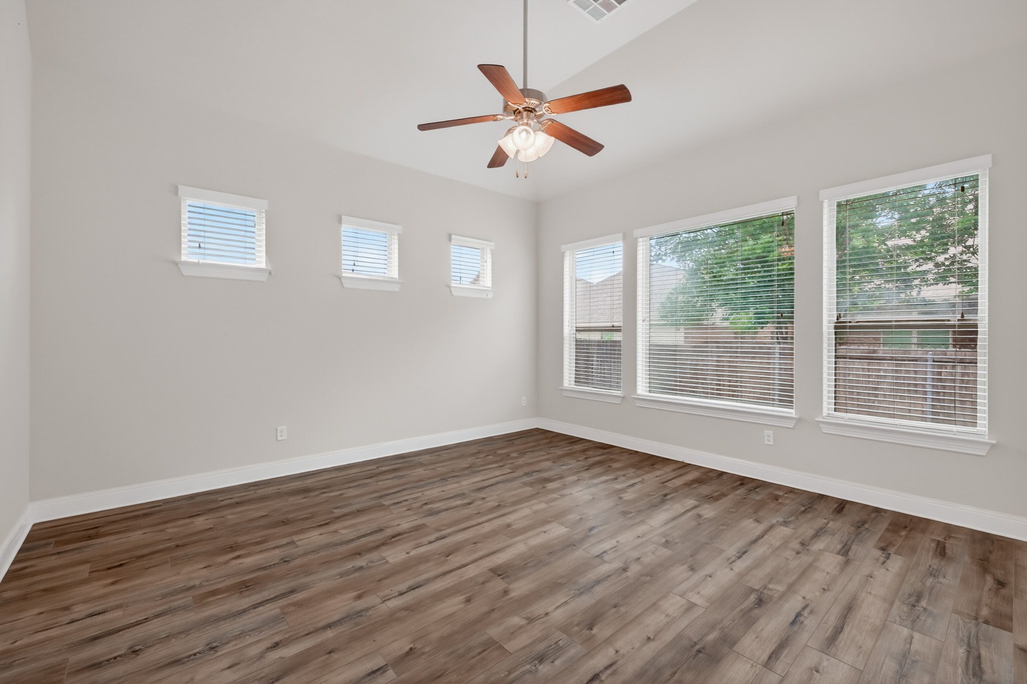 1017 Tabernash Leander, TX 78641 - Photo 31 of 38 Spacious room featuring wood-finish flooring, light grey walls, and a vaulted ceiling