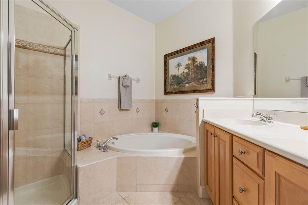 35 Ocean Crest Way, Unit 1124 Palm Coast, FL 32137 - Photo 21 of 81 a bathroom with a sink a mirror a bathtub and shower