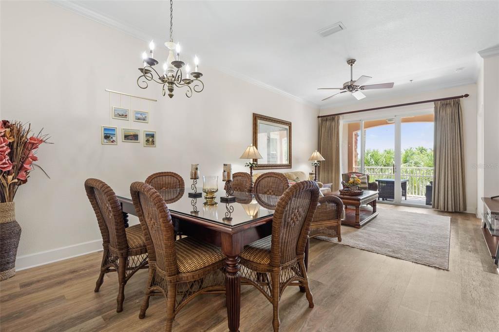 35 Ocean Crest Way, Unit 1124 Palm Coast, FL 32137 - Photo 3 of 81 a dining room with furniture a large window and wooden floor
