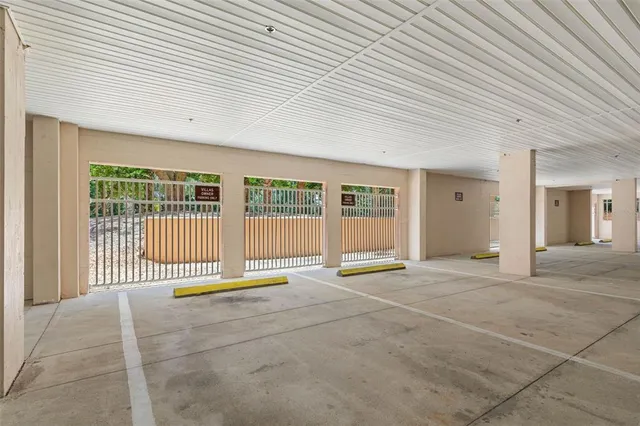 a view of a swimming pool with a yard and palm trees