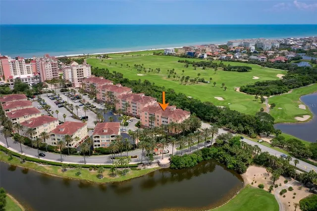 a view of a swimming pool with a table and chairs under an umbrella