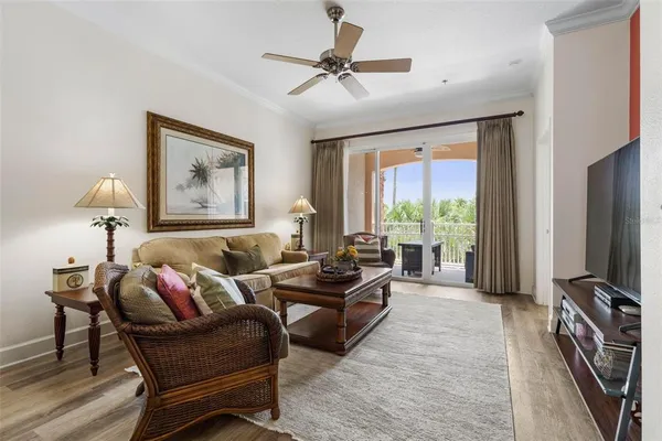 a living room with furniture and a chandelier