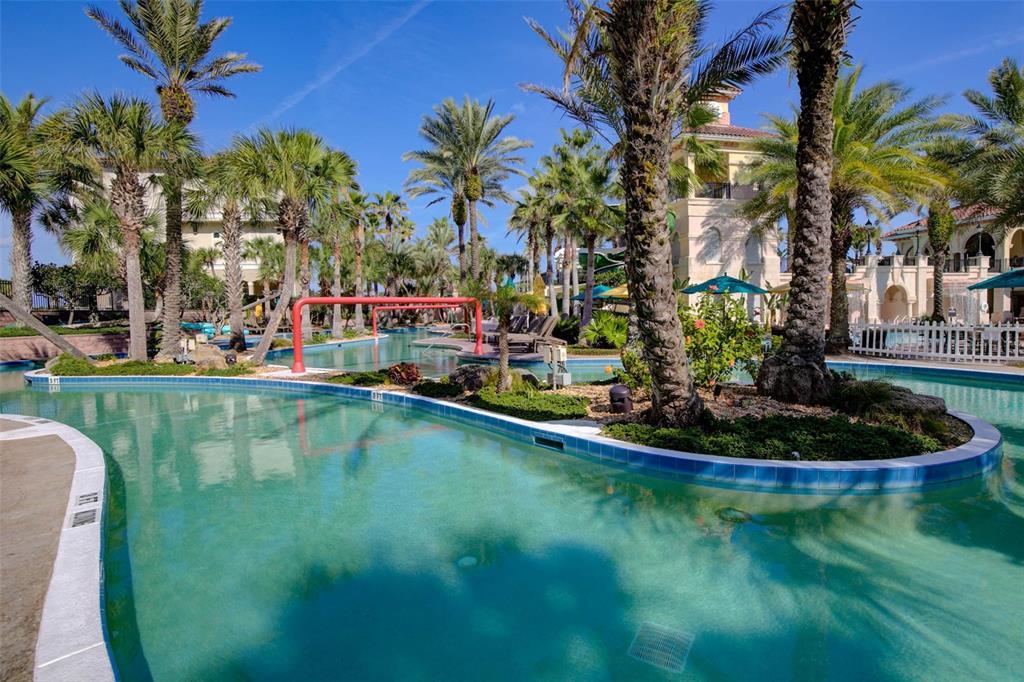 35 Ocean Crest Way, Unit 1124 Palm Coast, FL 32137 - Photo 47 of 81 a view of a swimming pool with a yard and palm trees