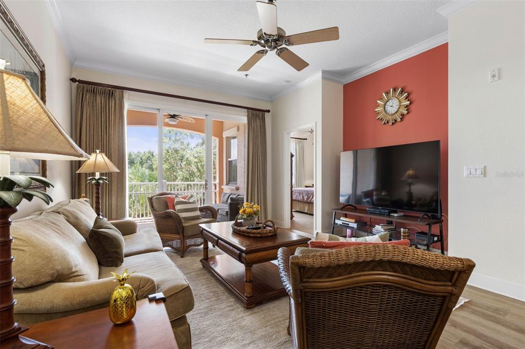 35 Ocean Crest Way, Unit 1124 Palm Coast, FL 32137 - Photo 5 of 81 a living room with furniture and a flat screen tv