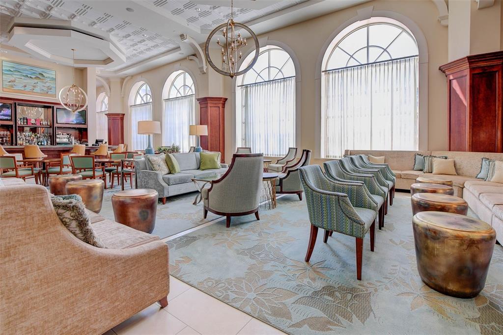 35 Ocean Crest Way, Unit 1124 Palm Coast, FL 32137 - Photo 77 of 81 a living room with furniture a large window and a clock
