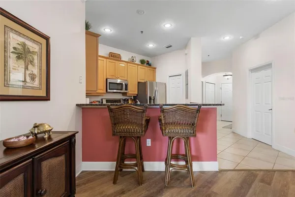 a kitchen with granite countertop a stove sink and cabinets