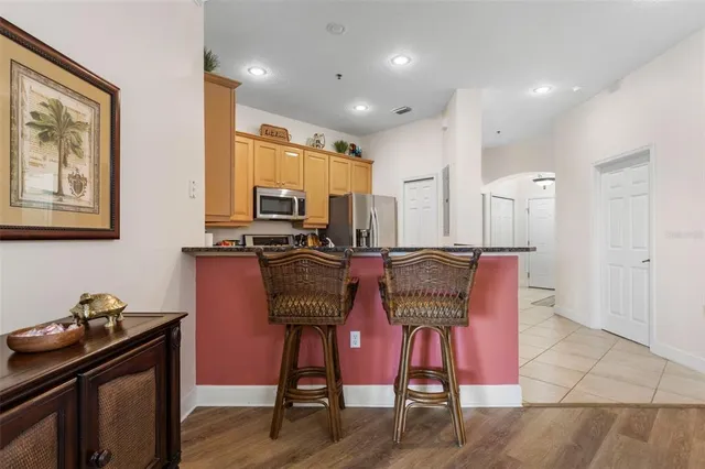 a kitchen with granite countertop a stove sink and cabinets