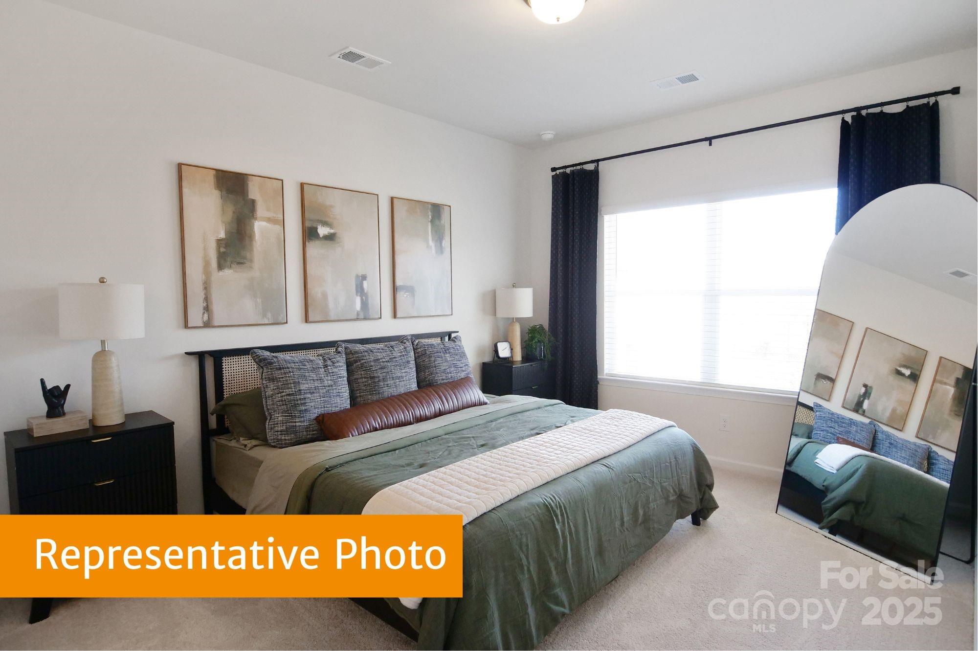 5620 Ringneck Road Charlotte, NC 28216 - Photo 14 of 24 a bedroom with a bed a mirror and a window