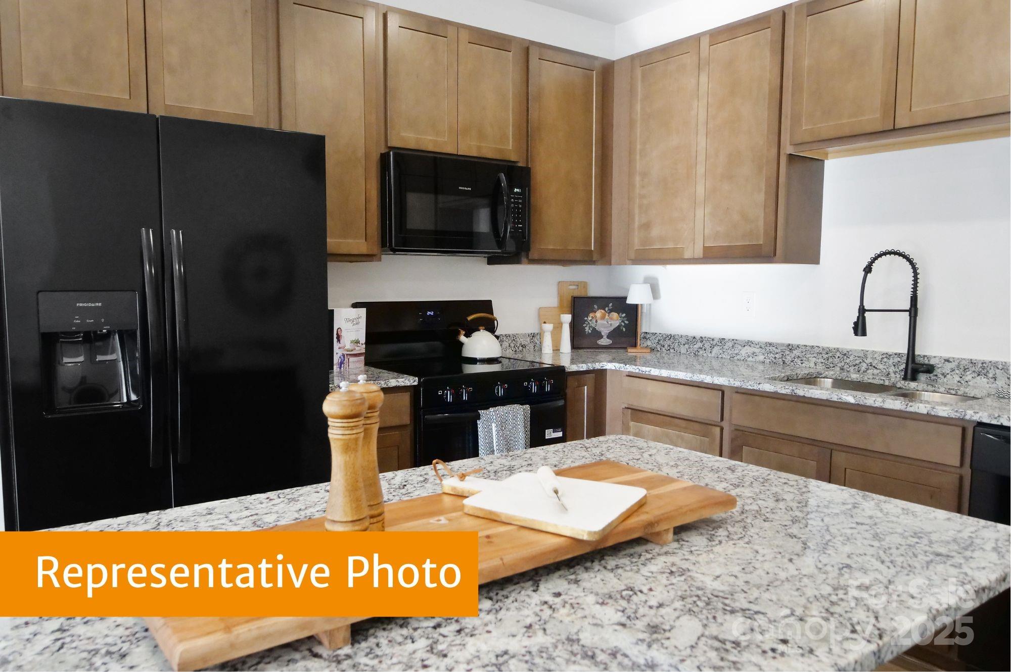 5620 Ringneck Road Charlotte, NC 28216 - Photo 5 of 24 a kitchen with stainless steel appliances granite countertop a refrigerator sink and stove