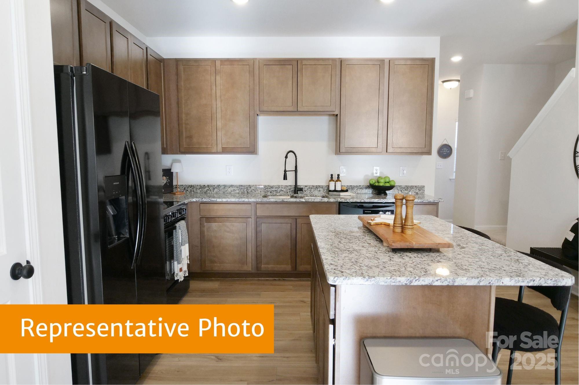 5620 Ringneck Road Charlotte, NC 28216 - Photo 6 of 24 a kitchen with stainless steel appliances granite countertop a sink refrigerator and cabinets