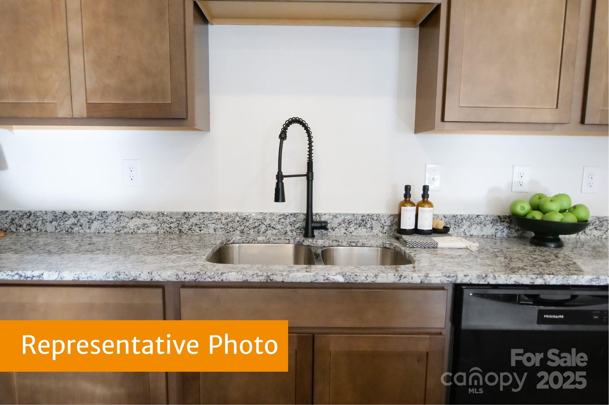 5620 Ringneck Road Charlotte, NC 28216 - Photo 7 of 24 a kitchen with granite countertop a sink stainless steel appliances and cabinets